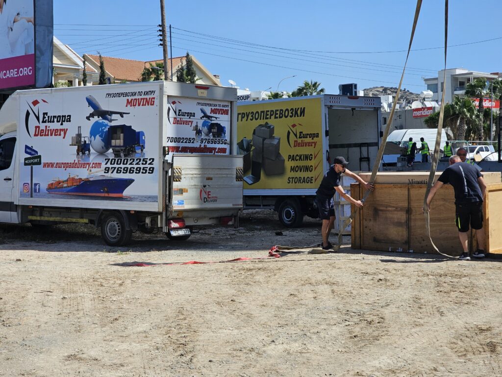 Europa Delivery fleet and moving team preparing a massive Minotti crate for a crane-assisted luxury furniture delivery in Cyprus